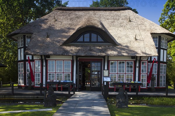 Thatched roof house Mikado Garden with Buddha rope