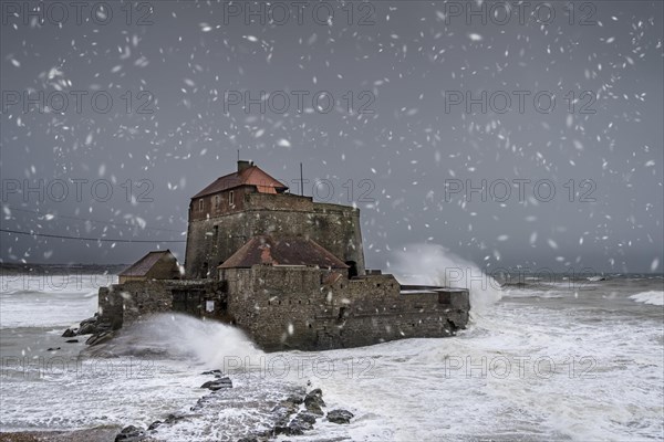 Waves crashing against Vauban's Fort Mahon near Ambleteuse during a winter storm on the North Sea coast