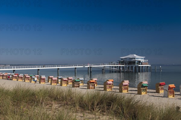 Beach chairs at Timmendorfer Strand with Seeschloesschenbruecke and Japanese teahouse