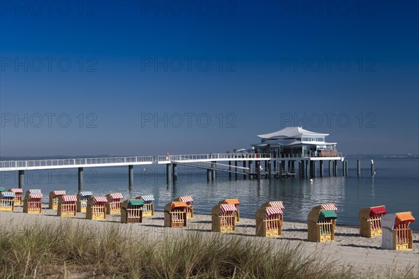 Beach chairs at Timmendorfer Strand with Seeschloesschenbruecke and Japanese teahouse