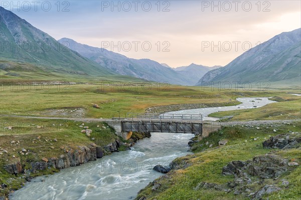 Wooden bridge over the mountain river