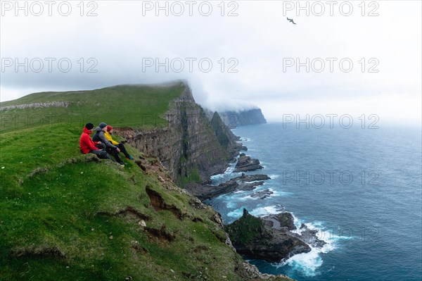 3 Walkers sitting overlooking Beinisforo Cliffs