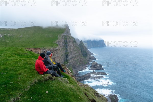 3 Walkers sitting overlooking Beinisforo Cliffs