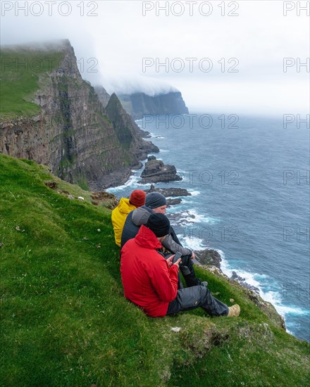 3 Walkers sitting overlooking Beinisforo Cliffs