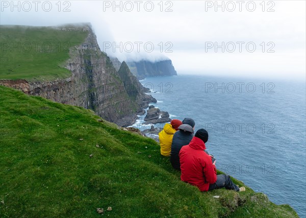 3 Walkers sitting overlooking Beinisforo Cliffs