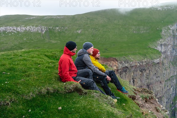 3 Walkers sitting overlooking Beinisforo Cliffs