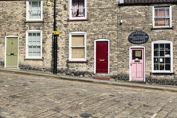 Street with cobblestones and old dwellings on the hillside