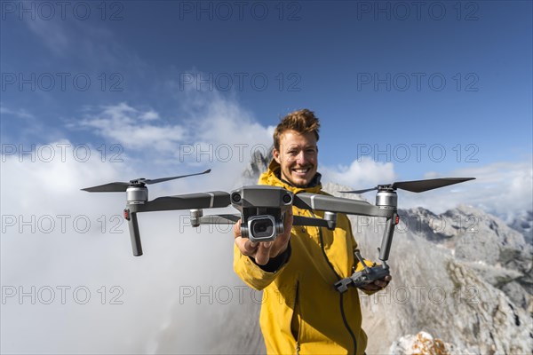 Young man holding a drone with camera