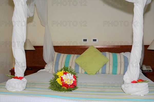 Bouquet of flowers on hotel bed