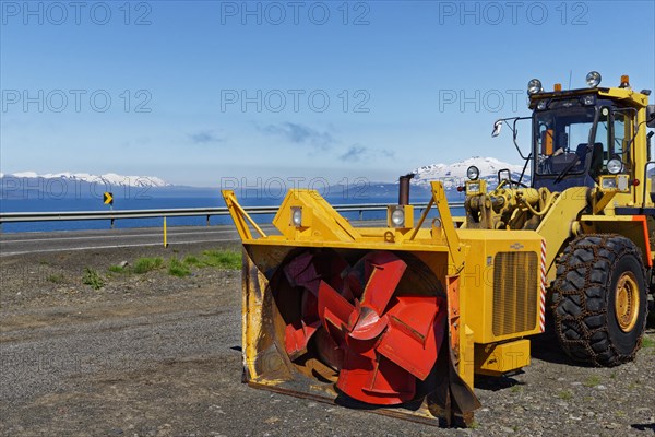 Wheel loader with snowblower and snow chains