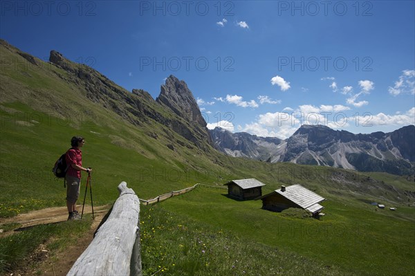 Hiker on the Seceda with Geislerspitzen