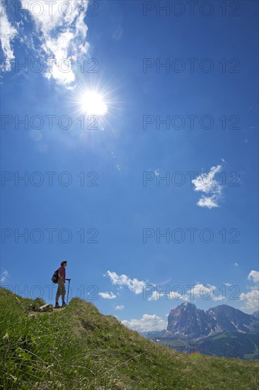 Hiking on the Seceda with view of Langkofel and Plattkofel