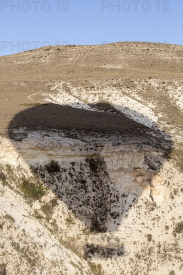 Shadow of hot air balloon flying over Cappadocia