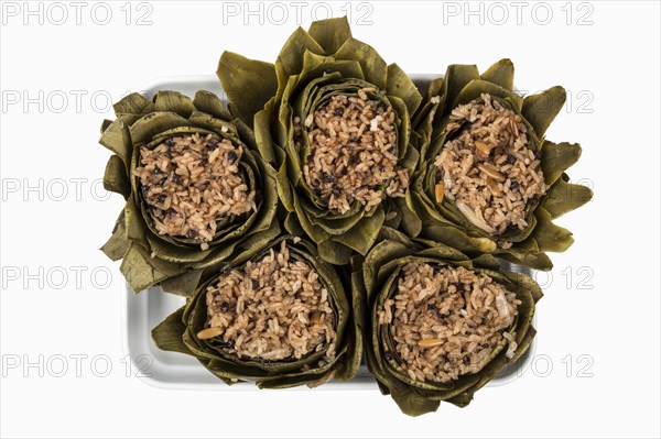 Plate with artichoke rice against a white background