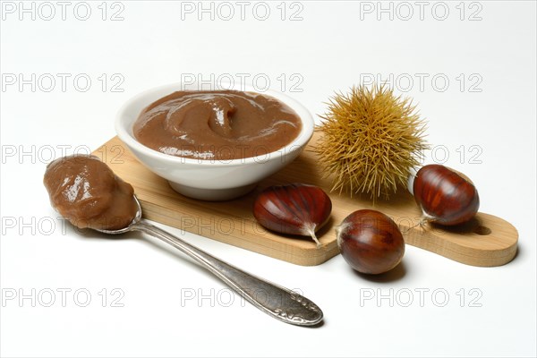 Chestnut cream in bowl on wooden board