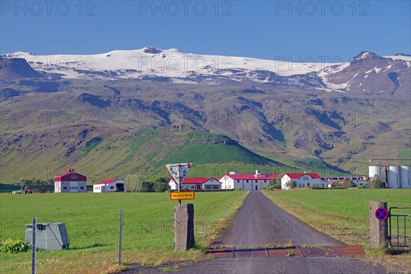 Farm in front of high mountains