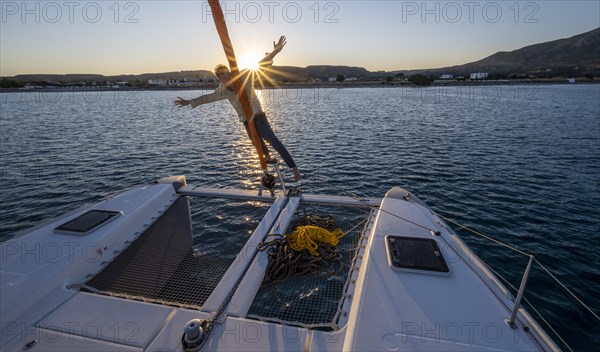 Young man standing by the foresail