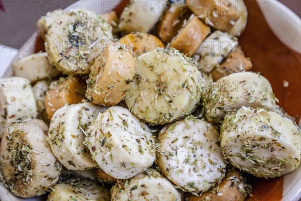 Fresh small goat cheese with oregano sold on the market in Portugal