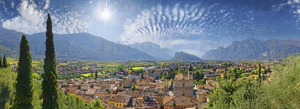 Old idyllic town surrounded by mountains with the Collegiata dell'Assunta church and fascinating sky