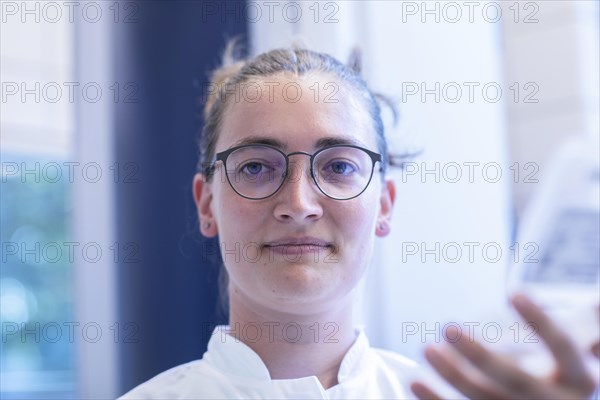 Young laboratory assistant portrait working in a laboratory with laboratory equipment