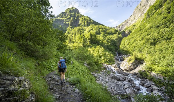 Hiker ascending the stream to the Kemptner Hut