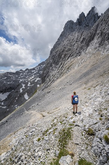 Hiker crossing a scree field