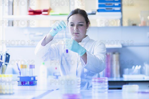 Lab technician pipetting a sample in the lab