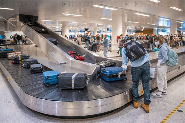 People waiting at baggage claim at an airport