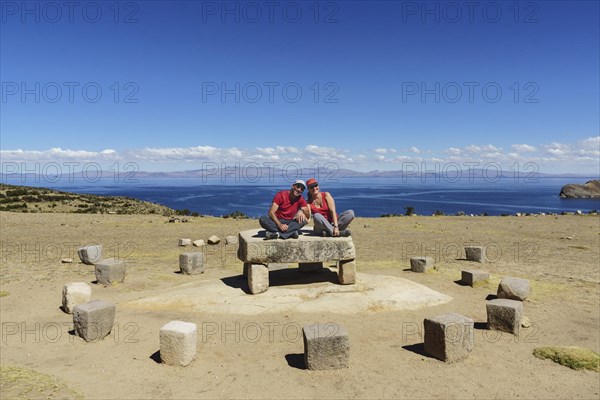 Older couple sitting on the Roca Sagrada