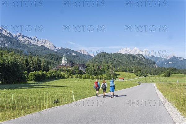 Three hikers in front of Elmau Castle