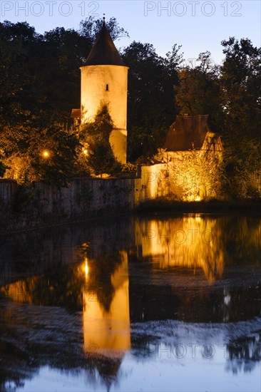 Illuminated town wall with septic tank and park keeper's house at the town pond