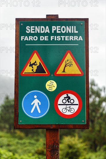 Wooden sign pedestrian way with traffic signs and warnings