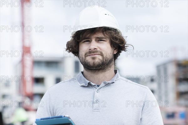 Technician with beard middle aged and working outside with polo shirt and helmet