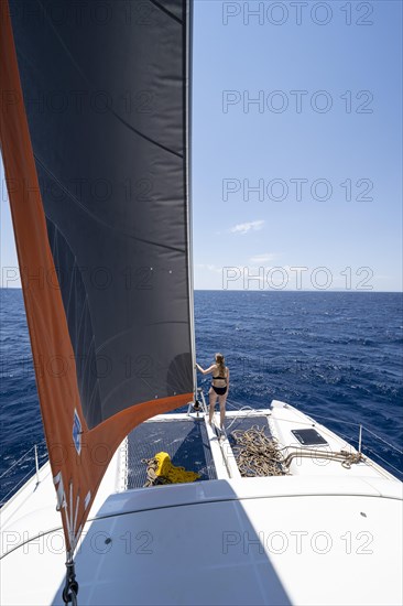 Young woman standing by the foresail