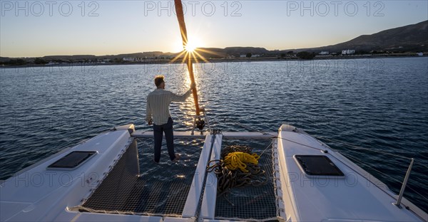 Young man standing by the foresail