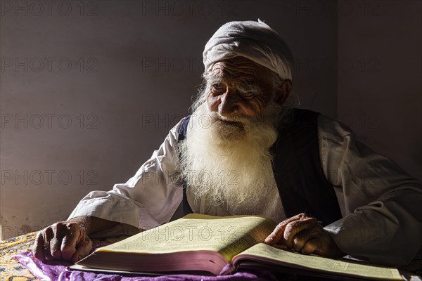 Sufi priest studying the holy Quran in the Shrine of Mawlana Abdur Rahman Jami