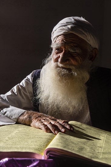 Sufi priest studying the holy Quran in the Shrine of Mawlana Abdur Rahman Jami