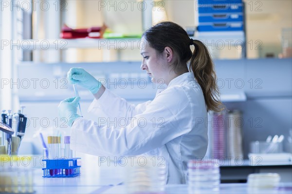 Lab technician pipetting a sample in the lab