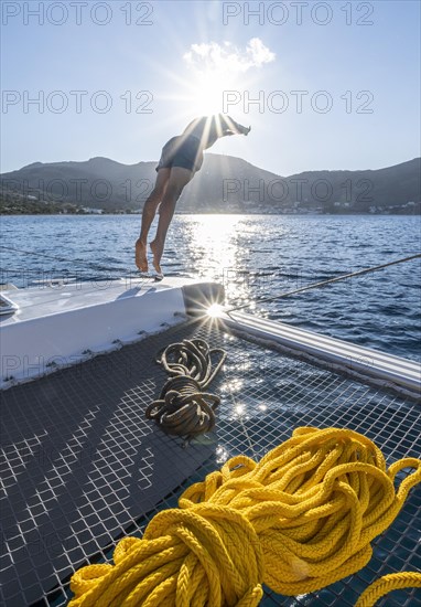 Young man jumps into the water