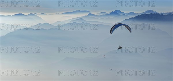 Paragliding with the peaks of the Garda Mountains and Bergamo Alps