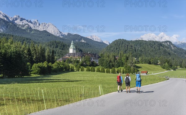 Three hikers in front of Elmau Castle