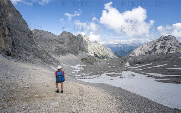 Hiker crossing a scree field