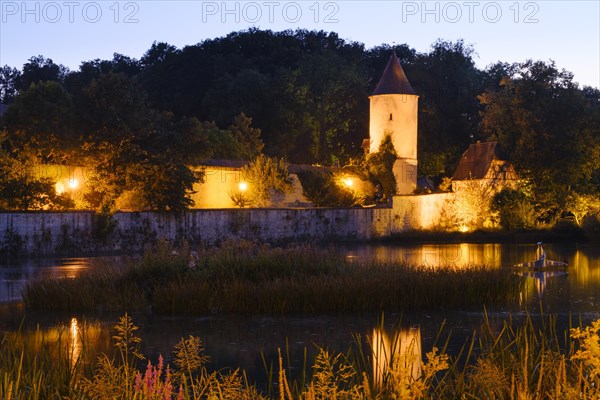 Illuminated town wall with septic tank and park keeper's house at the town pond