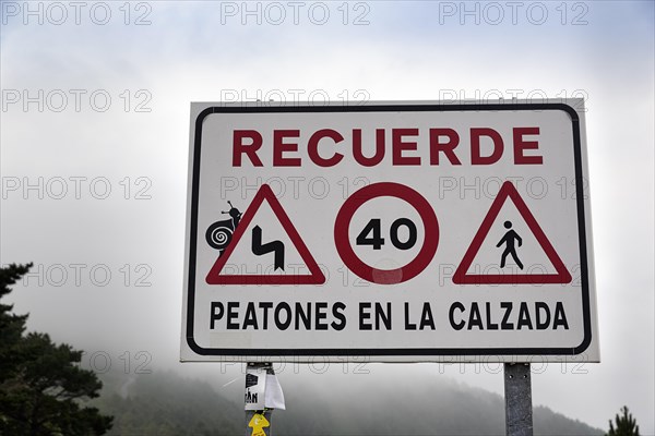 Sign with various traffic signs warning pedestrians on the road