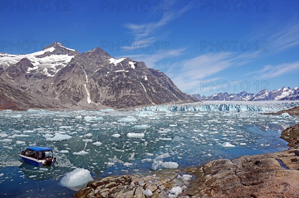 Boat in a fjord with drift ice