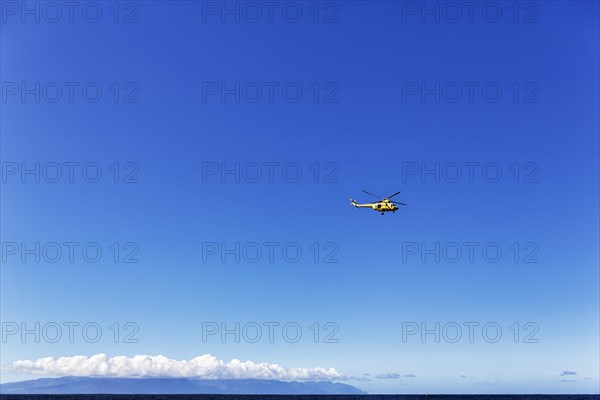Rescue helicopter flying over the sea