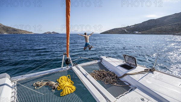 Young man jumps into the water