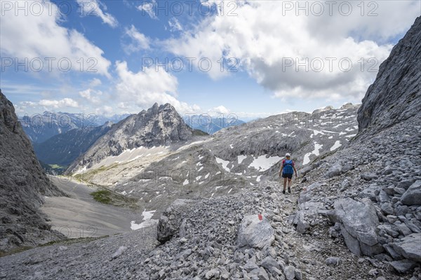 Hiker crossing a scree field