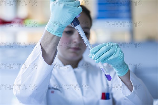 Lab technician pipetting a sample in the lab