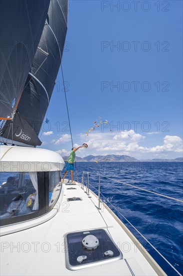 Young man throws food scraps overboard